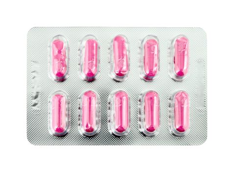 Pink pills pack on white background