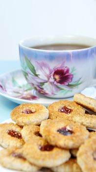 Tea porcelain cups and biscuits with marmalade                  
