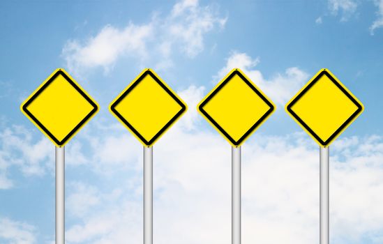Four blank yellow traffic sign with blue sky