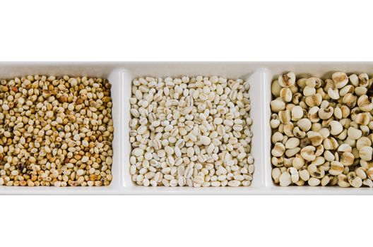  job's tears , barley and millet grains on white bowl
