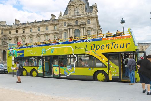 PARIS, FRANCE - JULY 10:Tourists bus in the heart of Paris on July 10, 2012. Paris is one of the most visited cities in the world