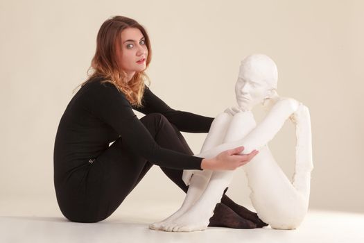 Young woman with her self-portrait in plaster