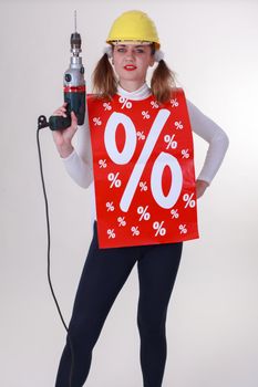 Young woman with drill and helmet Attract percent Action