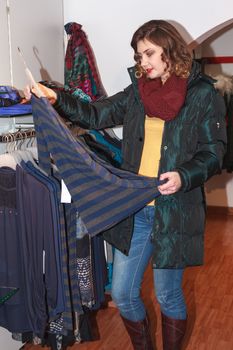 Young attractive woman in the store when purchasing textiles
