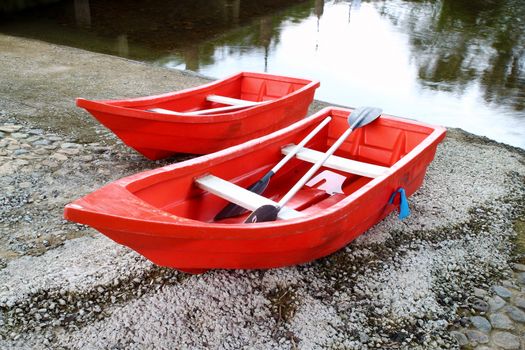 two red rowboat near the river