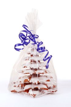 homemade christmas gingerbreads tree with blue ribbon on white background