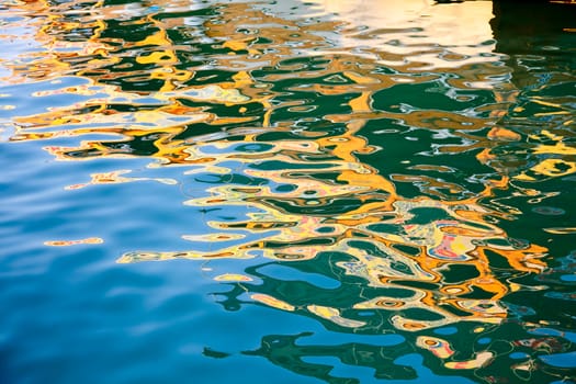 Abstract colorful reflection in rippled water surface