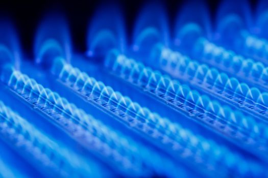 Blue flames of a gas burner inside of a boiler