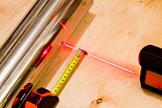 Measuring with tapemeasure tool and red laser beam