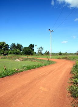 Soil road in countryside with blue sky