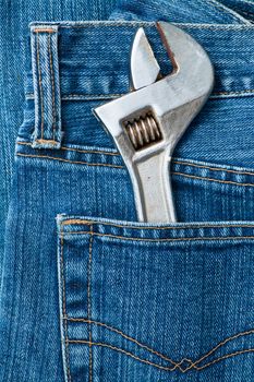 Blue jeans pocket with old adjustable spanner