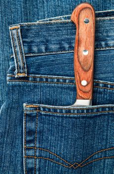 Blue jeans pocket with kitchen knife