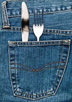 Blue jeans pocket with table knife and fork