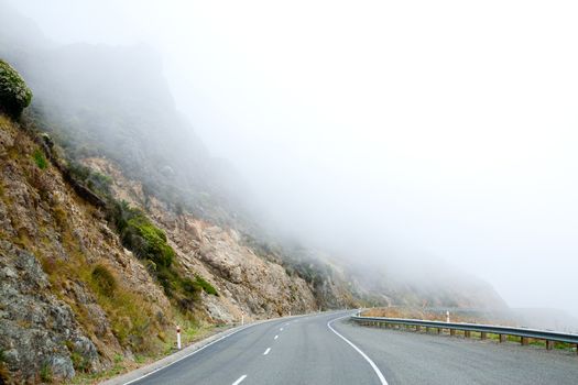 Mountain road in the Southern Alps of New Zealand on a foggy day