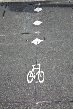 Empty asphalt cycle track with bike lane sign