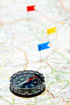 Compass on map with color flag pins