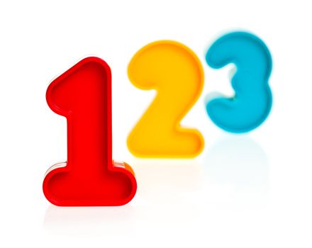 Colorful plastic numbers one two three on white background, focus on 1