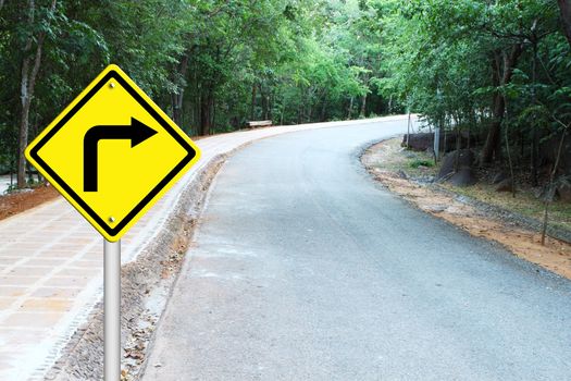 Turn right warning sign on a curve road