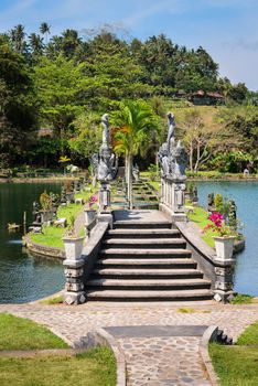 Decorated with dragons bridge in Royal water palace and pools in Tirthagangga, Bali island, Indonesia 