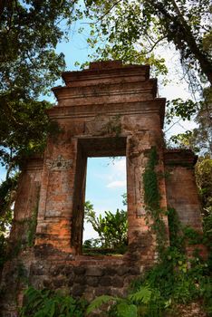 Blue sky through old  ruined Balinese doorway in a forest in Tirthagangga, Bali island, Indonesia 