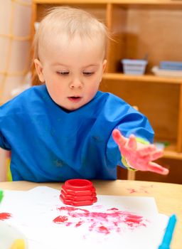 Little girl make finger paint