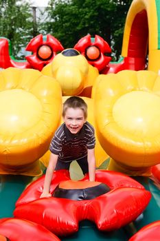 Young boy playing in inflatable playground