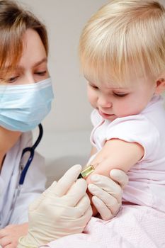 Doctor giving a child an intramuscular injection in arm