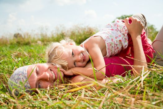 Young woman with cute little girl enjoying a summer day outdoors