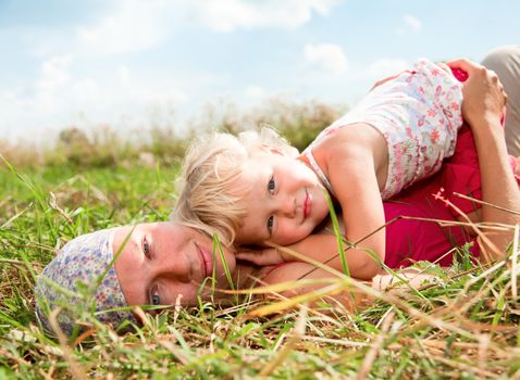 Young woman with cute little girl enjoying a summer day outdoors