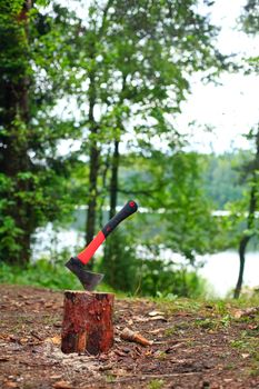 Camping axe stuck in a piece of wood