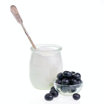 Old-fashioned yogurt jar with spoon and Blueberries on white background