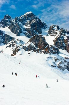Skiers on a piste at Alpine ski resort