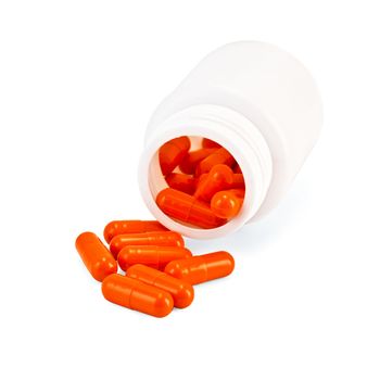 Orange capsules in a white jar isolated on white background