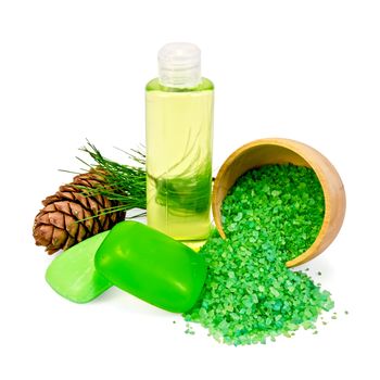Cedar cones with branch, two green soap, salt in a wooden bowl, shower gel isolated on white background