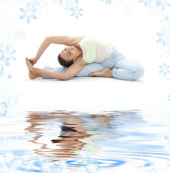 lovely girl practicing ashtanga yoga on white sand