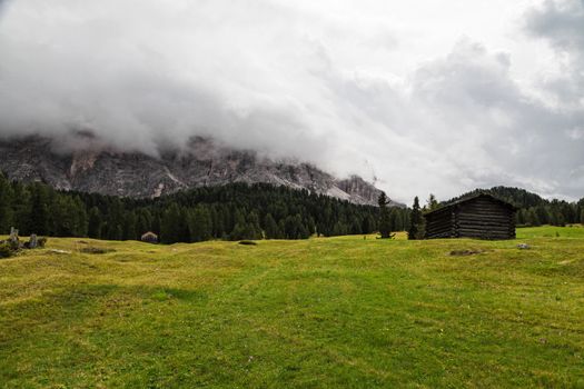 Green hill and cloudy sky