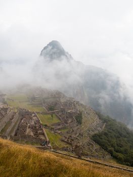 Morning views of Machu Picchu as mist clears from the mountainside