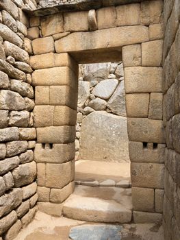 Morning views of Machu Picchu with detail of doorway in city