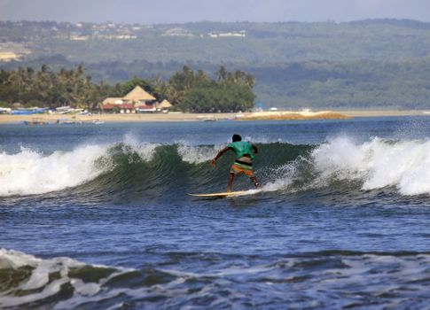 Man-surfer in ocean. Bali. Indonesia