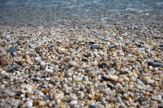 small pebbles in beach of the Mediterranean Sea, in Spain