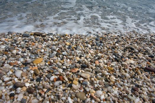 small pebbles in beach of the Mediterranean Sea, in Spain