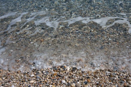 small pebbles in beach of the Mediterranean Sea, in Spain