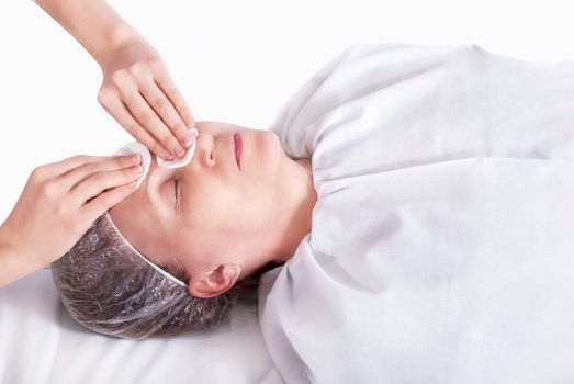 Beautiful woman in spa salon on the cleaning procedure of the face.