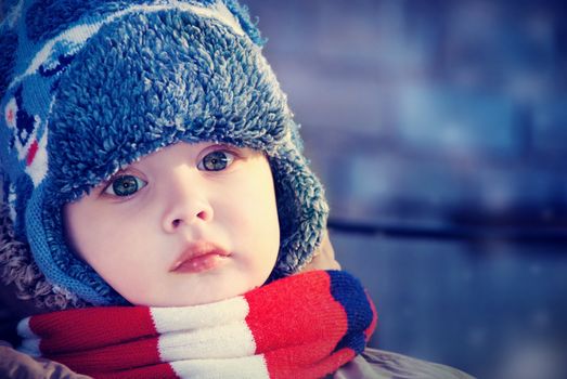 Closeup winter portrait of a child in winter hat.