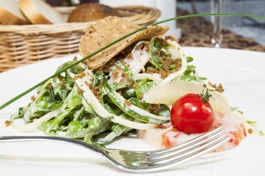 salad greens and shrimp meat on a white background