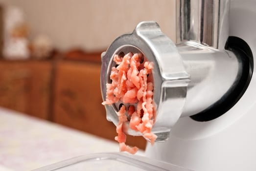 Electric meat mincer twist stuffing.Soft focus