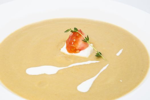 pea puree soup with goat cheese and tomatoes