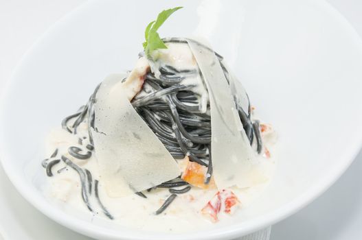 Black spaghetti with white sauce with cheese