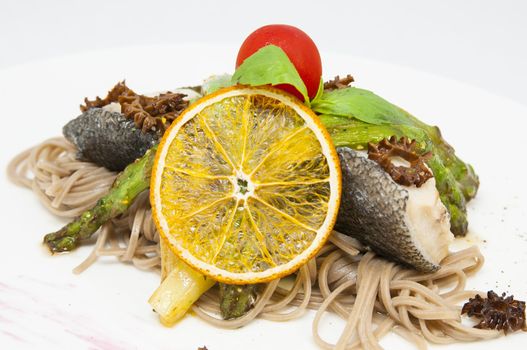 baked fish with spaghetti and mushrooms and vegetables