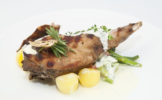 roasted rabbit meat and potatoes with vegetables